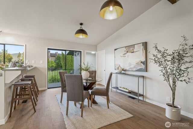 5110 NW Sammamish Rd, Issaquah, WA 98027 - dining space featuring wood finished floors, baseboards, and vaulted ceiling