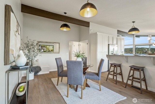 5110 NW Sammamish Rd, Issaquah, WA 98027 - dining room with wood finished floors, baseboards, and beam ceiling