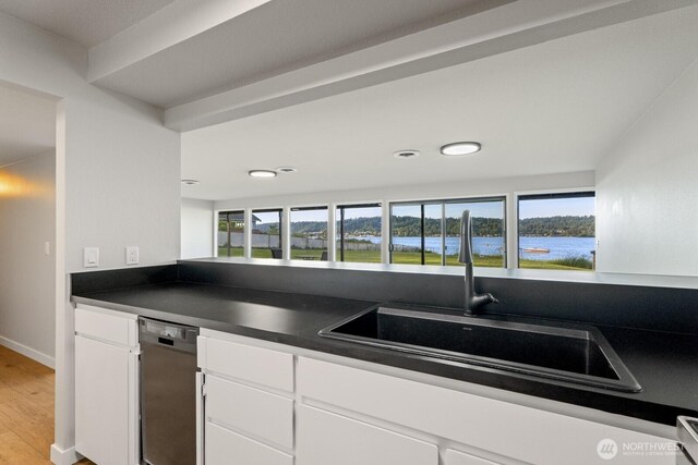 5110 NW Sammamish Rd, Issaquah, WA 98027 - kitchen with dark countertops, a sink, white cabinetry, light wood-style floors, and dishwasher