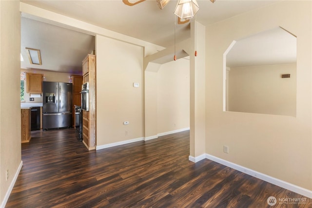 513 346th St E, Roy, WA 98580 - empty room featuring dark wood-style floors, ceiling fan, baseboards, and arched walkways