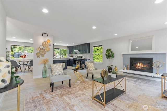 4426 NE 17th St, Renton, WA 98059 - living area with healthy amount of natural light, recessed lighting, a brick fireplace, light wood-style flooring, and baseboards