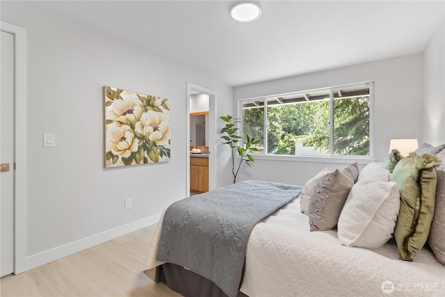 4426 NE 17th St, Renton, WA 98059 - bedroom with light wood-style flooring, baseboards, and ensuite bath