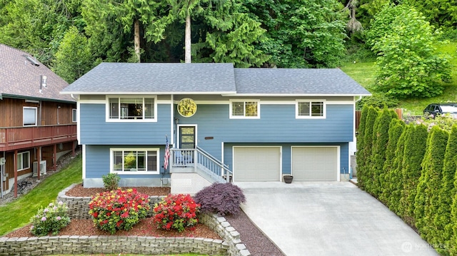 649 Summit Pl, Sedro Woolley, WA 98284 - split foyer home with concrete driveway, an attached garage, and a shingled roof