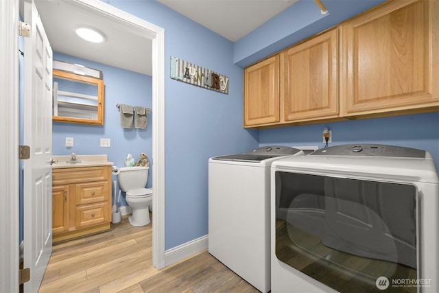 649 Summit Pl, Sedro Woolley, WA 98284 - laundry area featuring separate washer and dryer, light wood-style floors, baseboards, and cabinet space