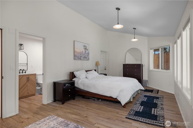 2711 Grampin Ct SE, Olympia, WA 98501 - bedroom featuring light wood finished floors, high vaulted ceiling, ensuite bathroom, and a sink