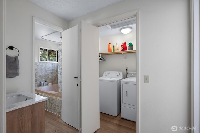 2711 Grampin Ct SE, Olympia, WA 98501 - laundry room with independent washer and dryer and wood finished floors