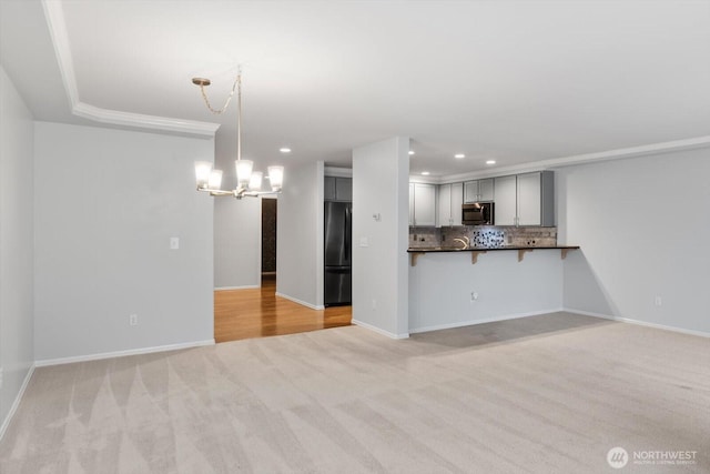 8221 53rd Ave W Unit G-27, Mukilteo, WA 98275 - unfurnished living room with light colored carpet, a chandelier, recessed lighting, and baseboards