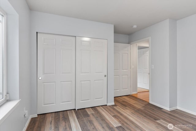 8221 53rd Ave W Unit G-27, Mukilteo, WA 98275 - unfurnished bedroom featuring wood finished floors, baseboards, and a closet