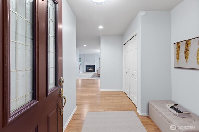 8221 53rd Ave W Unit G-27, Mukilteo, WA 98275 - entrance foyer featuring light wood-style flooring, recessed lighting, baseboards, and a glass covered fireplace