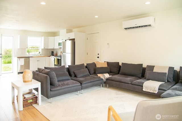 1022 Peach Rd, Winlock, WA 98596 - living room featuring a wall mounted air conditioner, recessed lighting, and light wood finished floors