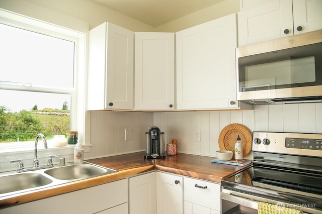 1022 Peach Rd, Winlock, WA 98596 - kitchen with stainless steel appliances, a sink, butcher block counters, and white cabinets