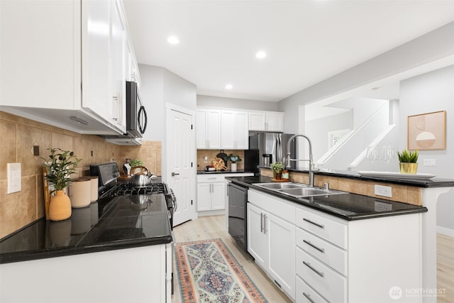 17826 20th Ave SE, Bothell, WA 98012 - kitchen featuring appliances with stainless steel finishes, dark countertops, light wood-style floors, a center island with sink, and recessed lighting