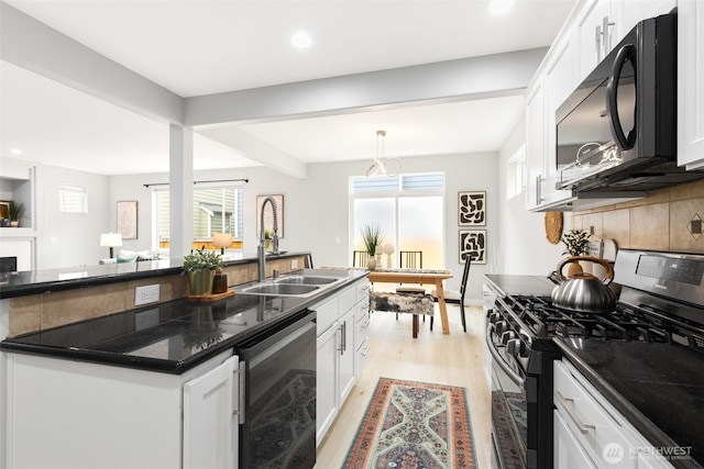 17826 20th Ave SE, Bothell, WA 98012 - kitchen with stainless steel gas range oven, dishwasher, black microwave, light wood finished floors, and white cabinets