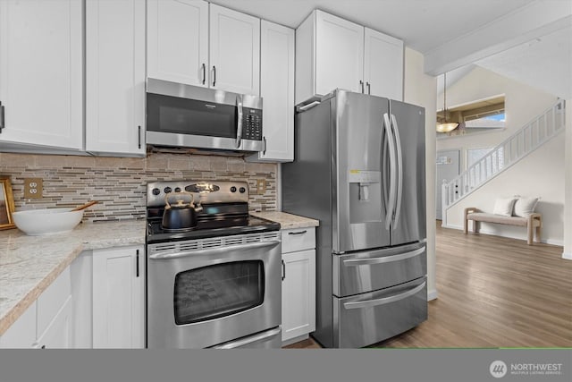 18805 20th Ave SE, Bothell, WA 98012 - kitchen featuring stainless steel appliances, tasteful backsplash, white cabinetry, and wood finished floors
