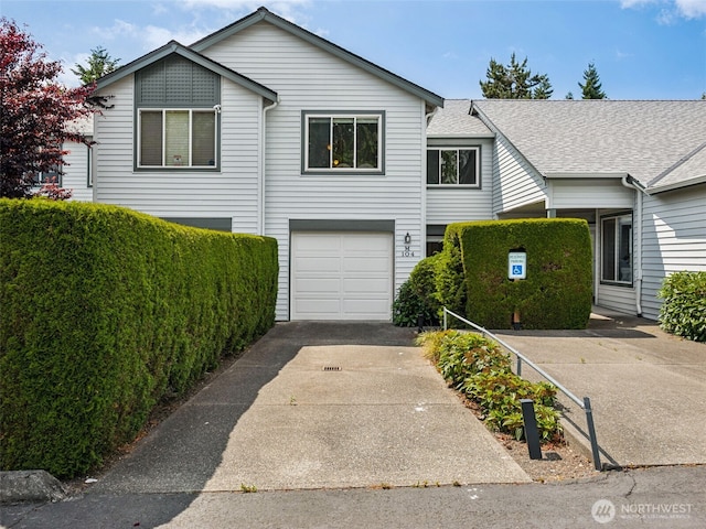 23501 112th Ave SE Unit M104, Kent, WA 98031 - view of front of property with an attached garage, concrete driveway, and a shingled roof