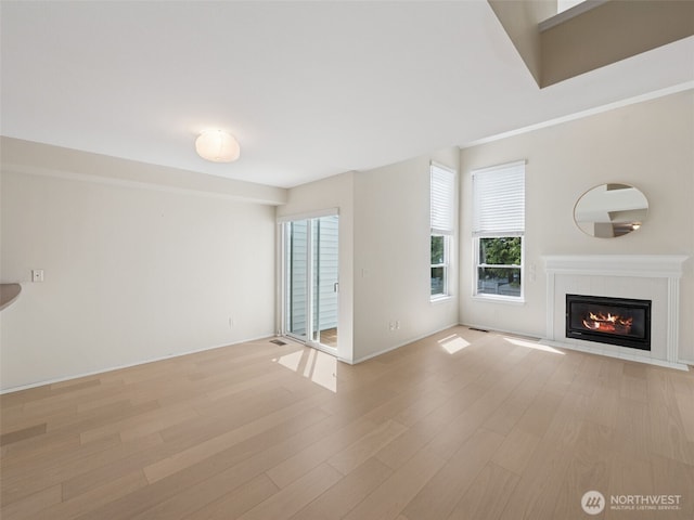 23501 112th Ave SE Unit M104, Kent, WA 98031 - unfurnished living room with light wood-style floors, a fireplace, and baseboards