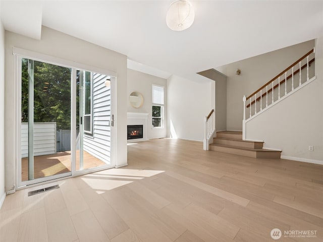 23501 112th Ave SE Unit M104, Kent, WA 98031 - foyer with wood finished floors, plenty of natural light, stairway, and a lit fireplace