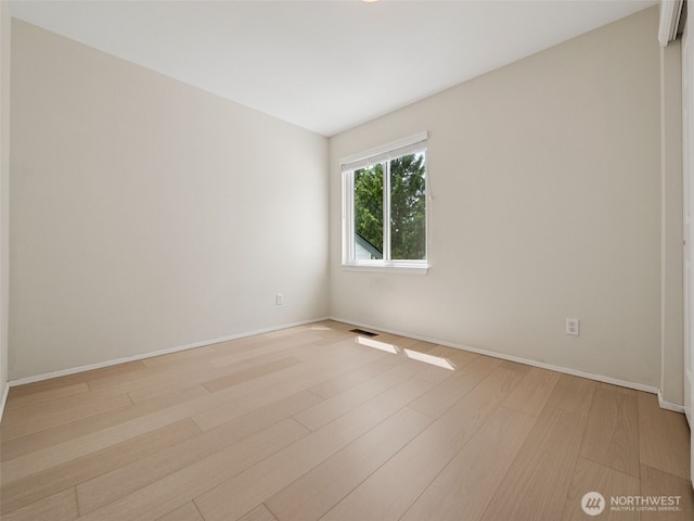 23501 112th Ave SE Unit M104, Kent, WA 98031 - empty room with light wood finished floors and baseboards