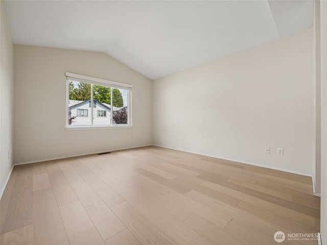 23501 112th Ave SE Unit M104, Kent, WA 98031 - empty room featuring light wood-type flooring, lofted ceiling, and baseboards