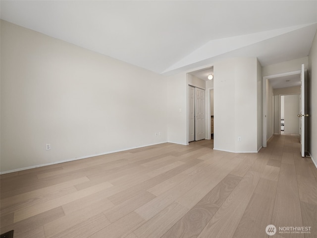 23501 112th Ave SE Unit M104, Kent, WA 98031 - unfurnished room featuring vaulted ceiling, light wood-type flooring, and baseboards