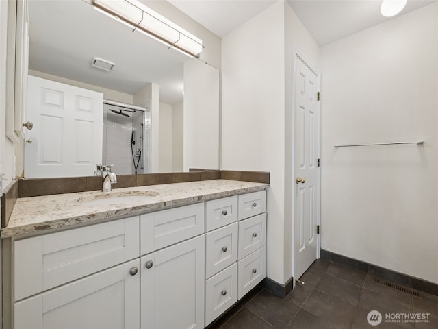 23501 112th Ave SE Unit M104, Kent, WA 98031 - full bath with vanity, an enclosed shower, baseboards, and tile patterned flooring