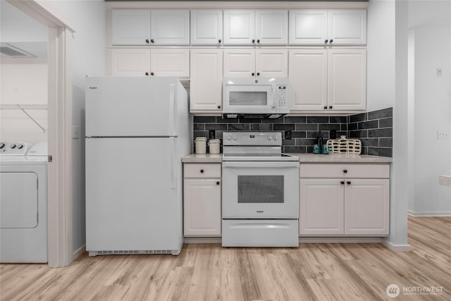 2009 196th St SE Unit G104, Bothell, WA 98012 - kitchen with white appliances, separate washer and dryer, light countertops, and white cabinets