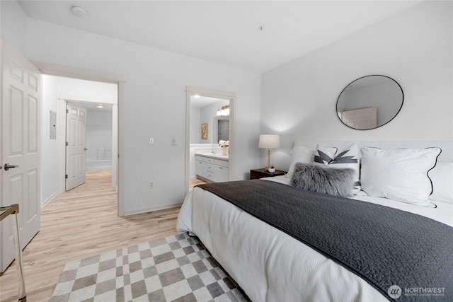 2009 196th St SE Unit G104, Bothell, WA 98012 - bedroom featuring light wood-style flooring, baseboards, and ensuite bath