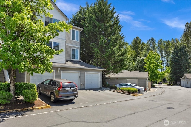 2009 196th St SE Unit G104, Bothell, WA 98012 - view of front of house featuring a garage and asphalt driveway