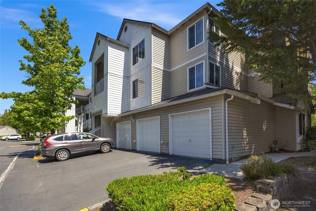 2009 196th St SE Unit G104, Bothell, WA 98012 - view of side of property featuring an attached garage and driveway