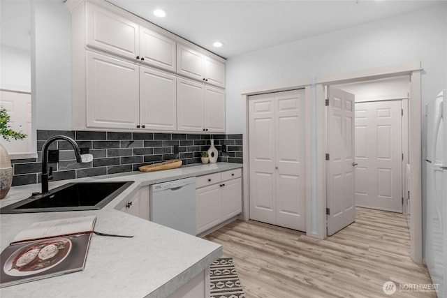 2009 196th St SE Unit G104, Bothell, WA 98012 - kitchen with white appliances, a sink, white cabinetry, light countertops, and recessed lighting