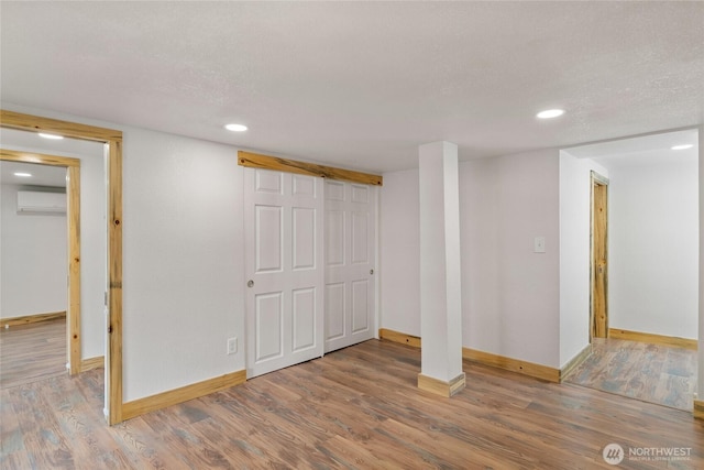 330 Highland Ave, Chelan, WA 98816 - finished below grade area with a wall mounted AC, baseboards, wood finished floors, and recessed lighting