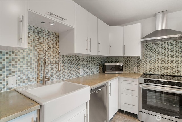 330 Highland Ave, Chelan, WA 98816 - kitchen featuring a sink, wall chimney range hood, appliances with stainless steel finishes, and light countertops