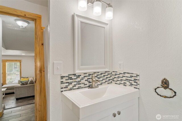 330 Highland Ave, Chelan, WA 98816 - bathroom featuring vanity, backsplash, ensuite bathroom, and wood finished floors