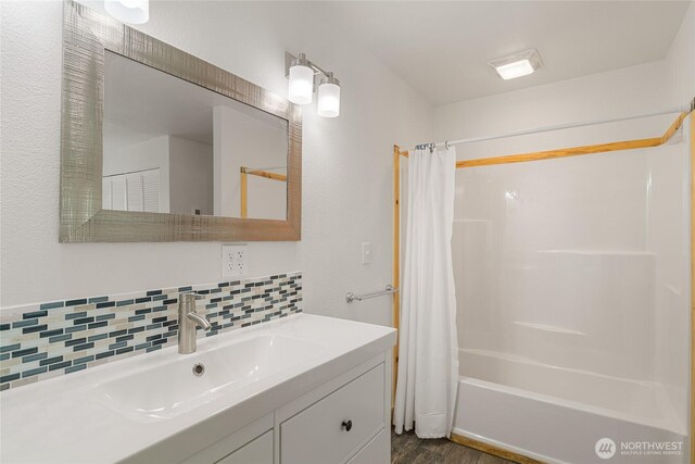 330 Highland Ave, Chelan, WA 98816 - full bathroom featuring decorative backsplash, vanity, shower / bathtub combination with curtain, and wood finished floors