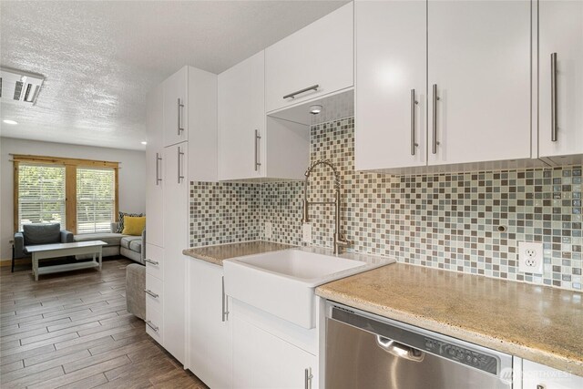 330 Highland Ave, Chelan, WA 98816 - kitchen with dishwasher, a sink, white cabinetry, tasteful backsplash, and a textured ceiling