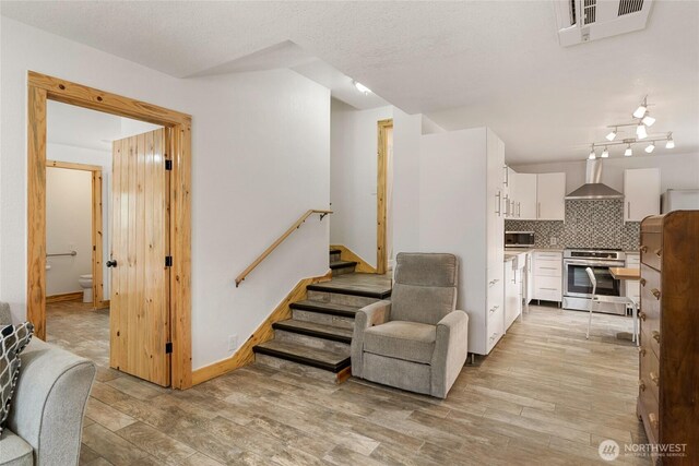 330 Highland Ave, Chelan, WA 98816 - sitting room with light wood-style flooring, stairs, and baseboards