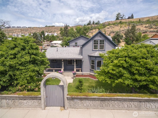 330 Highland Ave, Chelan, WA 98816 - view of front of property featuring covered porch, a gate, a fenced front yard, and a shingled roof