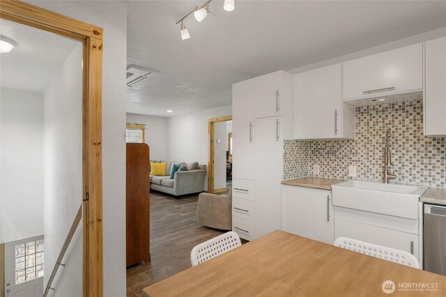 330 Highland Ave, Chelan, WA 98816 - kitchen with a sink, backsplash, light countertops, white cabinets, and wood finished floors