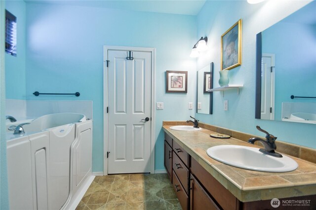 9127 Perwinkle Loop NE, Olympia, WA 98516 - full bath featuring double vanity, a garden tub, and baseboards