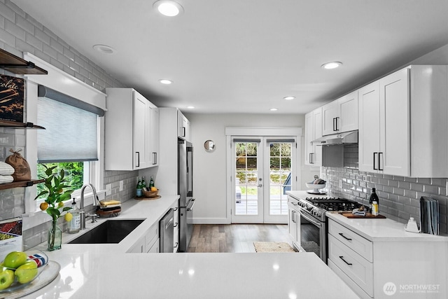3236 15th Ave S, Seattle, WA 98144 - kitchen with appliances with stainless steel finishes, under cabinet range hood, plenty of natural light, light countertops, and recessed lighting