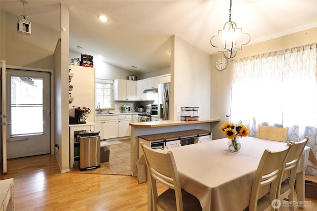19523 71st Ave E, Spanaway, WA 98387 - dining space with lofted ceiling, light wood-style floors, and recessed lighting