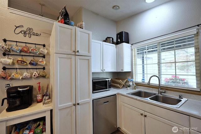 19523 71st Ave E, Spanaway, WA 98387 - kitchen featuring stainless steel appliances, a sink, white cabinetry, and light countertops