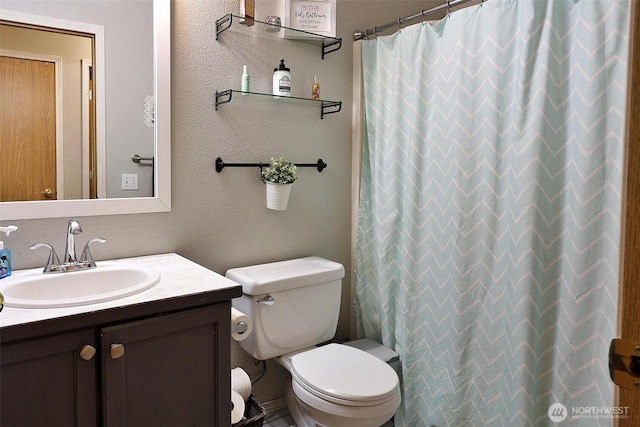 19523 71st Ave E, Spanaway, WA 98387 - full bathroom with vanity, toilet, a textured wall, and a shower with shower curtain