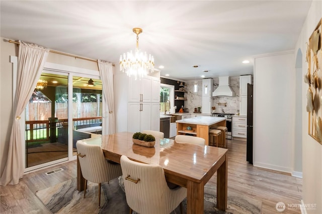 18113 17th Avenue Ct E, Spanaway, WA 98387 - dining space with light wood-style flooring, a chandelier, and recessed lighting