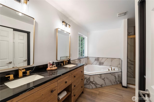 18113 17th Avenue Ct E, Spanaway, WA 98387 - bathroom featuring a bath, double vanity, wood finished floors, and a walk in shower