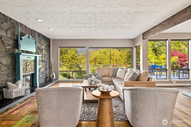 41506 292nd Way SE, Enumclaw, WA 98022 - living area featuring hardwood / wood-style flooring, a textured ceiling, and a fireplace