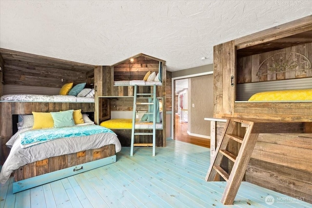 41506 292nd Way SE, Enumclaw, WA 98022 - bedroom featuring wooden walls, wood-type flooring, and a textured ceiling