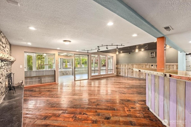 41506 292nd Way SE, Enumclaw, WA 98022 - unfurnished living room with a textured ceiling, hardwood / wood-style flooring, a wainscoted wall, recessed lighting, and wood walls