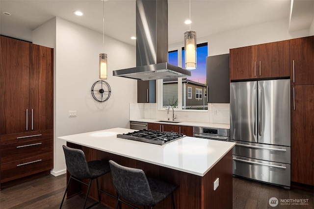 818 25th Ave S Unit A, Seattle, WA 98144 - kitchen with stainless steel appliances, island exhaust hood, a kitchen island, dark wood-style flooring, and light countertops