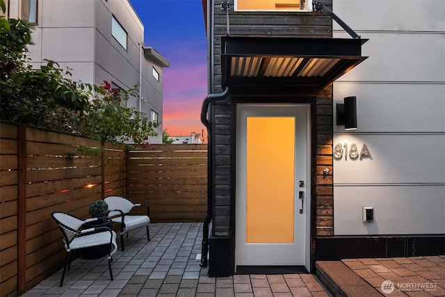818 25th Ave S Unit A, Seattle, WA 98144 - exterior entry at dusk featuring a patio